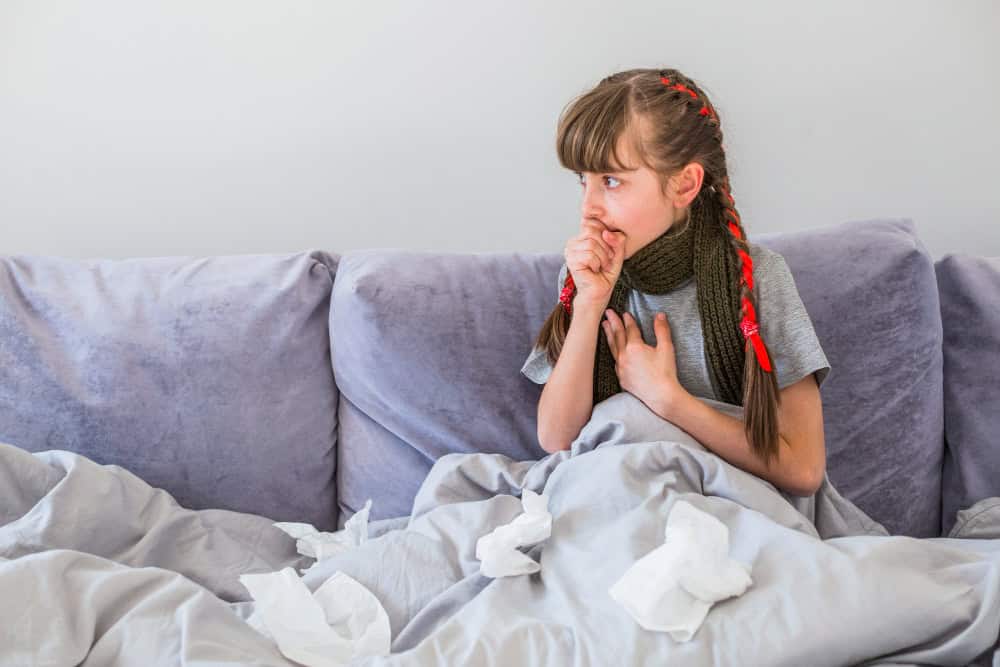 young girl in bed showing signs of bronchiolitis