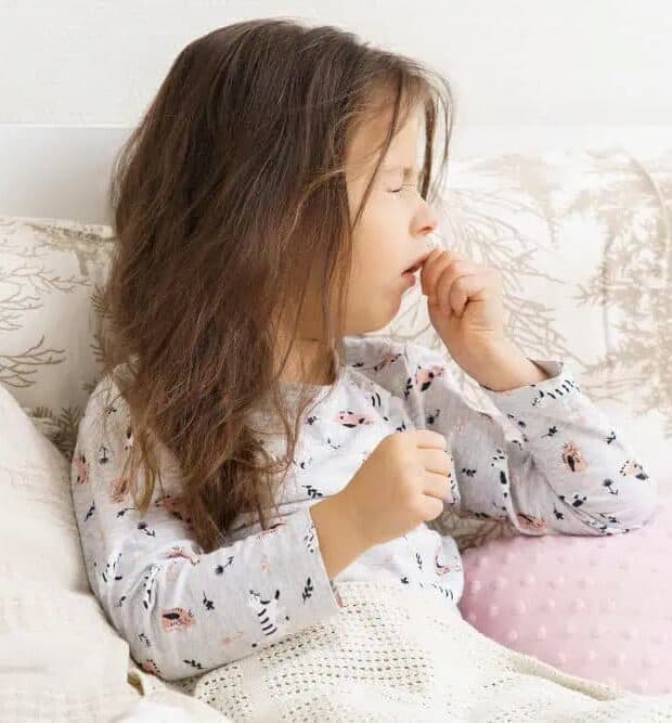 little girl in bed with whooping cough