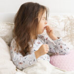 little girl in bed with whooping cough