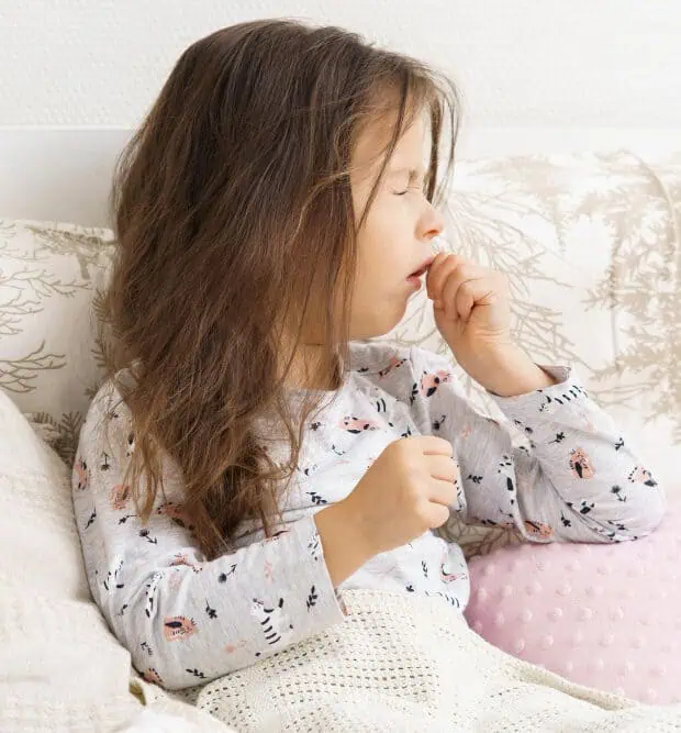 little girl in bed with whooping cough