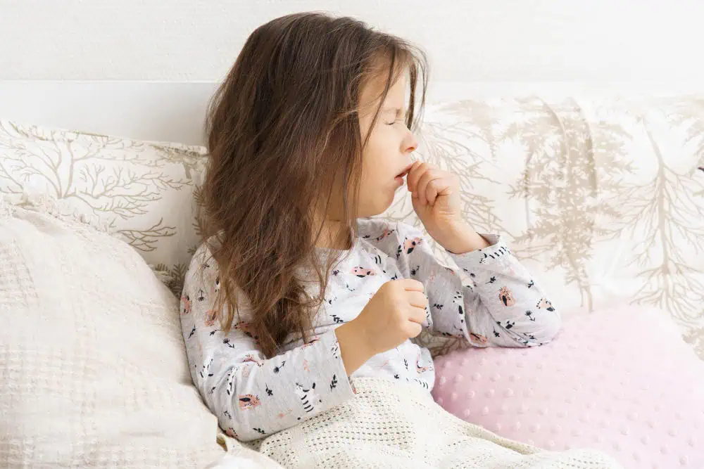 little girl in bed with whooping cough